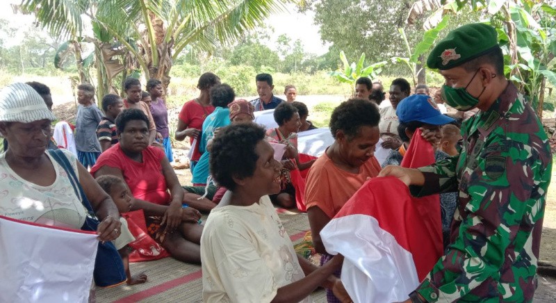 Jelang HUT RI Ke 75, Satgas Yonif 125 Bagikan Bendera Merah Putih Pada Warga Kampung Sota Dan Toray
